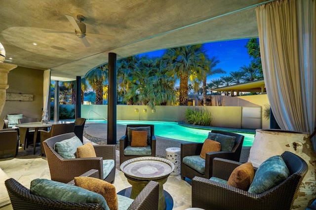 exterior space with ceiling fan and a fenced in pool