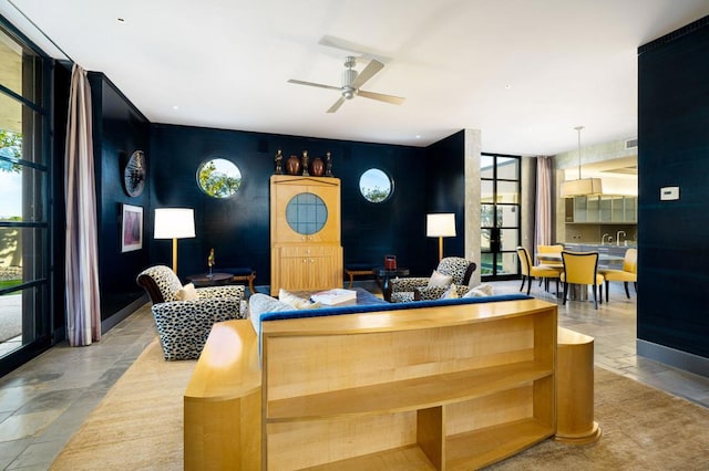 living room with ceiling fan and floor to ceiling windows