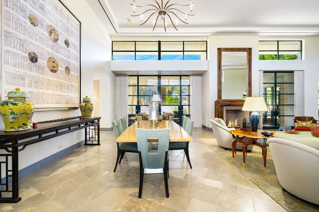 dining area with a high ceiling and a chandelier