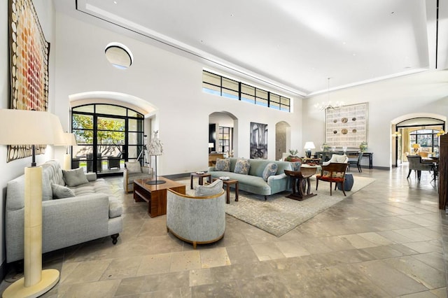 living room featuring a high ceiling and a notable chandelier