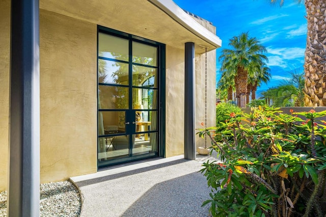 view of exterior entry featuring a patio