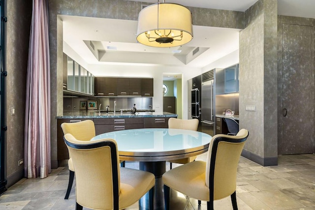 dining room with a raised ceiling