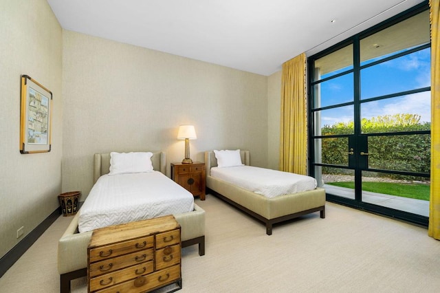 bedroom with carpet, access to exterior, and floor to ceiling windows