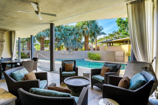 view of patio with ceiling fan and a fenced in pool