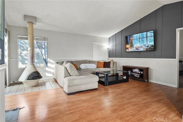 living room featuring vaulted ceiling and light hardwood / wood-style flooring