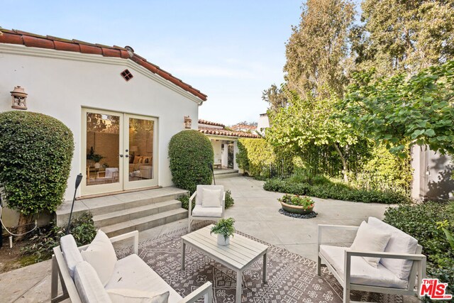 view of patio featuring an outdoor living space and french doors