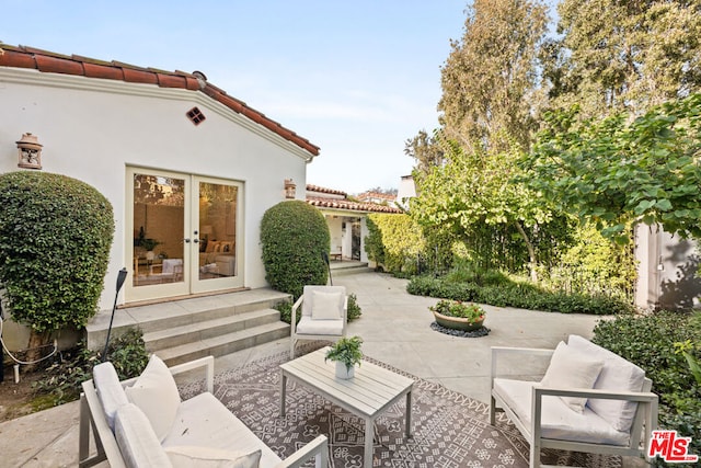 view of patio / terrace with french doors and an outdoor living space