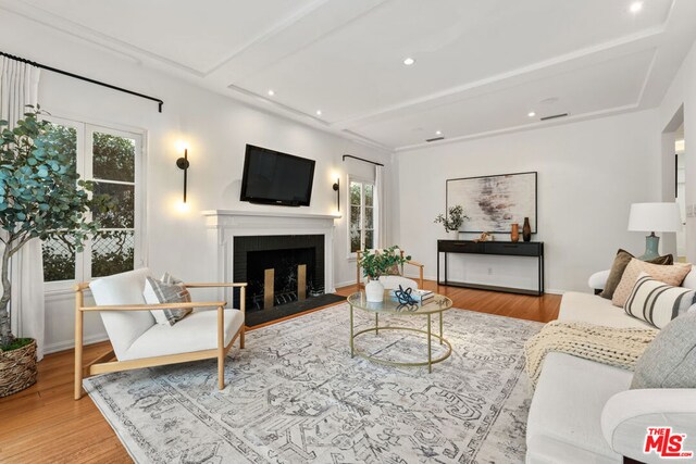 living room with hardwood / wood-style flooring, plenty of natural light, and beam ceiling