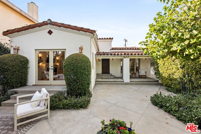 rear view of house featuring a patio area and french doors