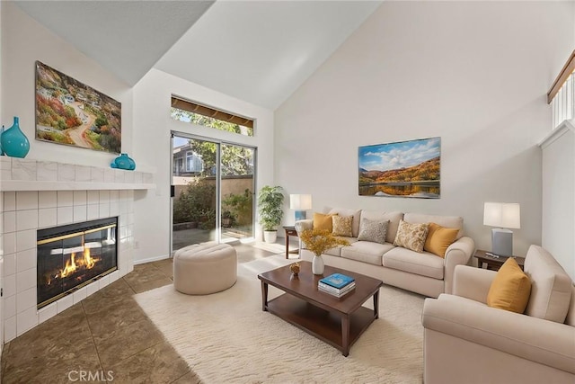 tiled living room featuring high vaulted ceiling and a fireplace