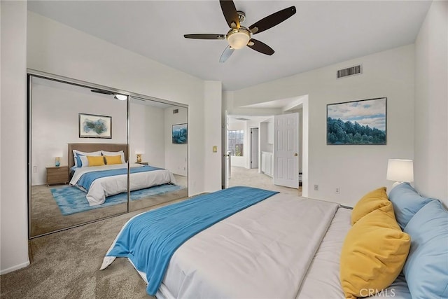 carpeted bedroom featuring ceiling fan and a closet