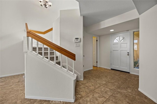 foyer entrance featuring an inviting chandelier