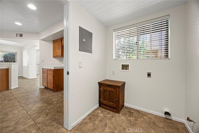 laundry area featuring hookup for a washing machine, electric panel, hookup for an electric dryer, and tile patterned flooring