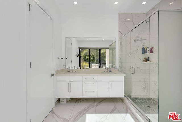 bathroom featuring vanity and a shower with door