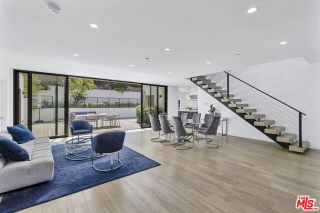 living room featuring light wood-type flooring and expansive windows