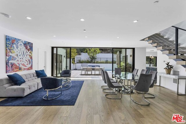 living room with floor to ceiling windows and wood-type flooring