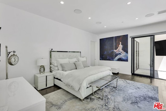 bedroom featuring access to outside and dark hardwood / wood-style flooring