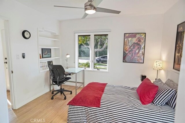 bedroom with ceiling fan and light wood-type flooring