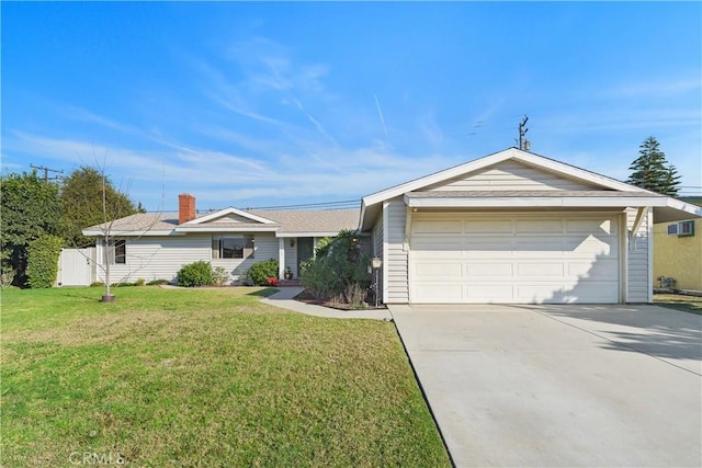 ranch-style house featuring a front yard and a garage