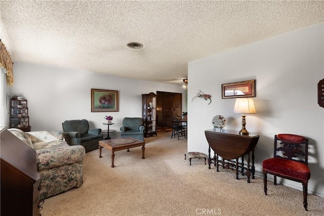 living room with light colored carpet and a textured ceiling