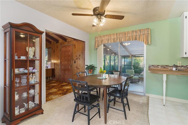 dining area featuring a textured ceiling and ceiling fan