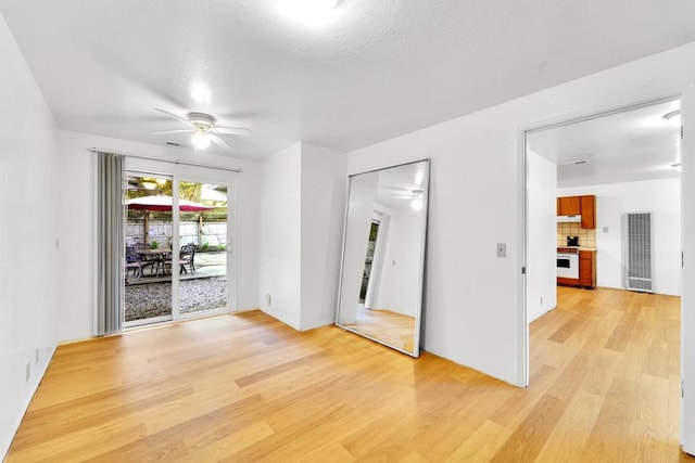 empty room featuring ceiling fan and light hardwood / wood-style floors