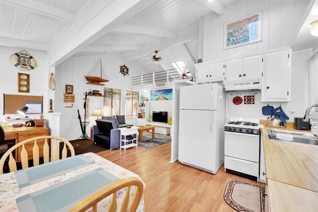 kitchen with beamed ceiling, sink, light wood-type flooring, white cabinets, and white appliances