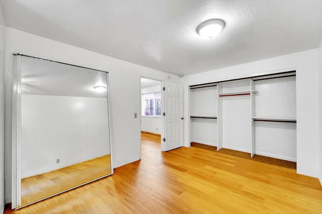 unfurnished bedroom featuring hardwood / wood-style floors and a closet