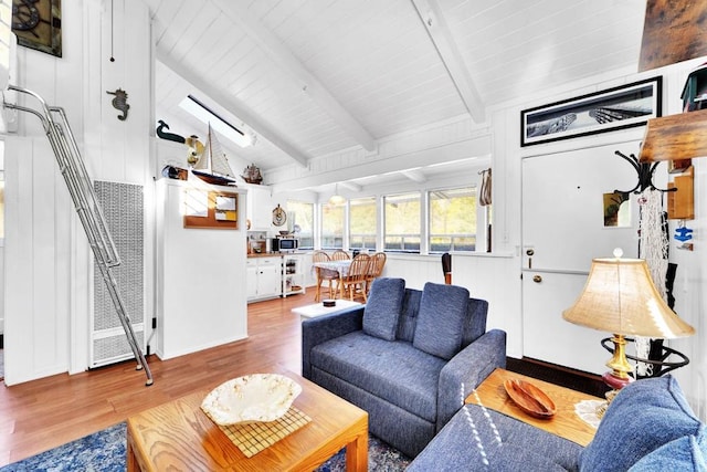 living room with lofted ceiling with beams, wood ceiling, and light hardwood / wood-style floors