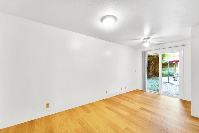 spare room with hardwood / wood-style flooring and a textured ceiling