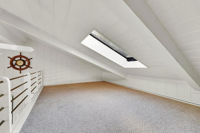 bonus room with lofted ceiling with skylight and carpet