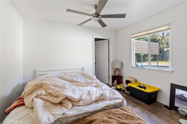 bedroom featuring dark wood-style floors, ceiling fan, and baseboards