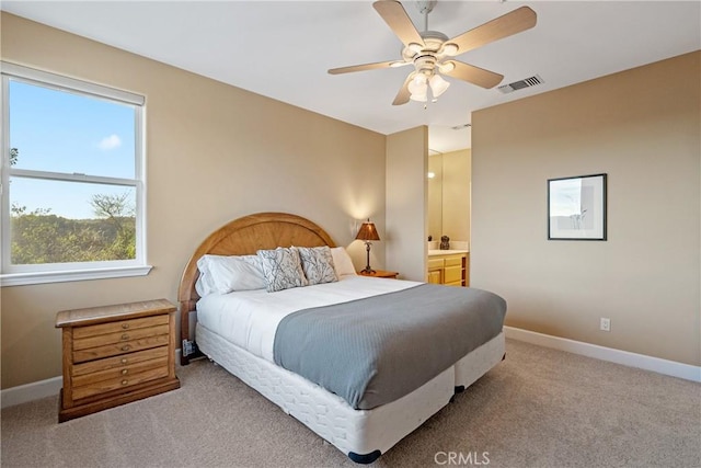 carpeted bedroom with baseboards, visible vents, ceiling fan, and connected bathroom