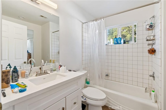 bathroom featuring visible vents, vanity, toilet, and shower / bathtub combination with curtain