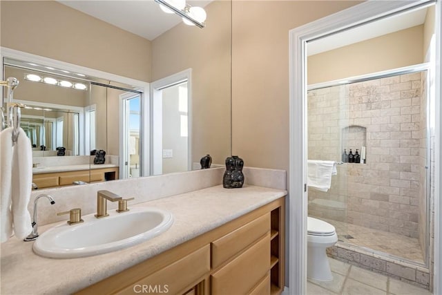 full bathroom featuring tile patterned flooring, toilet, a shower stall, and vanity