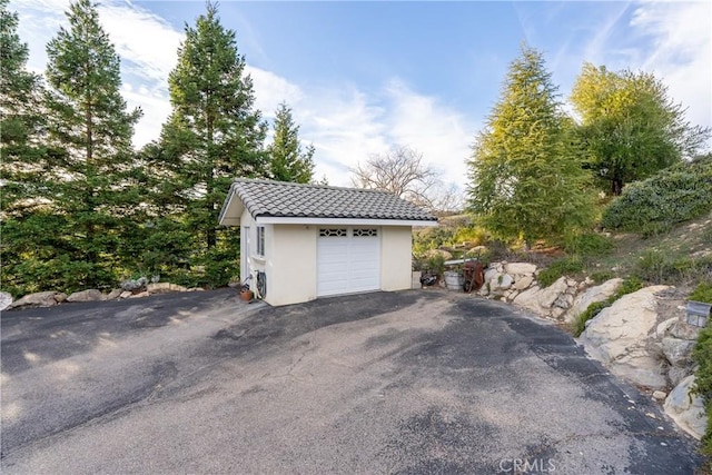 detached garage featuring driveway