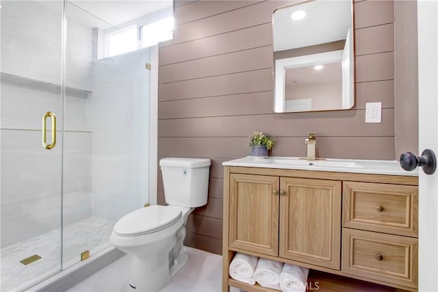 bathroom with vanity, a shower with shower door, and toilet