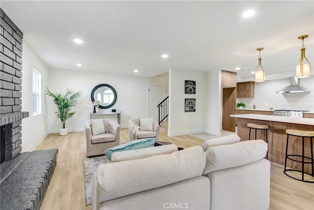 living room featuring a fireplace and light wood-type flooring