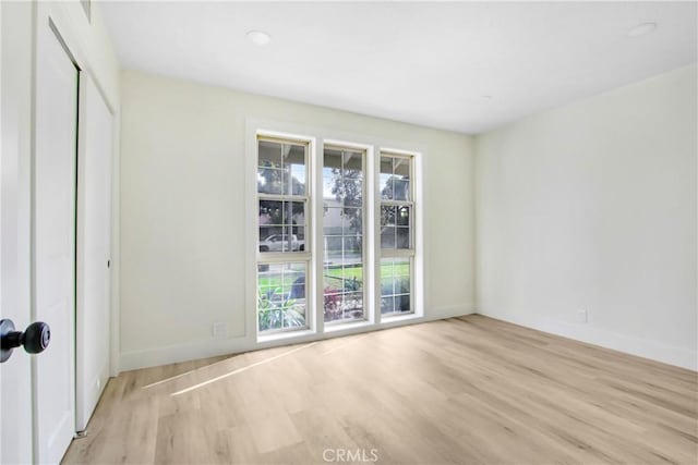 spare room featuring light hardwood / wood-style floors