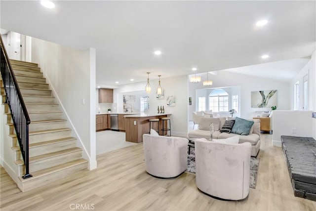 living room featuring vaulted ceiling and light hardwood / wood-style flooring