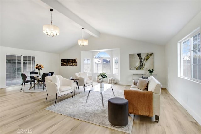 living room with an inviting chandelier, lofted ceiling with beams, and light wood-type flooring