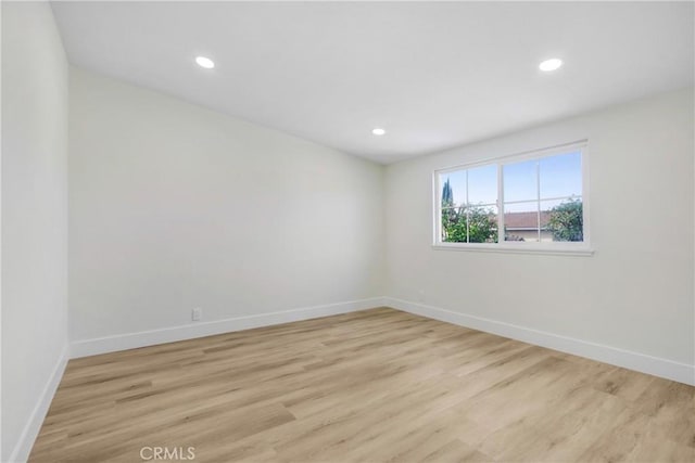 empty room with light hardwood / wood-style flooring