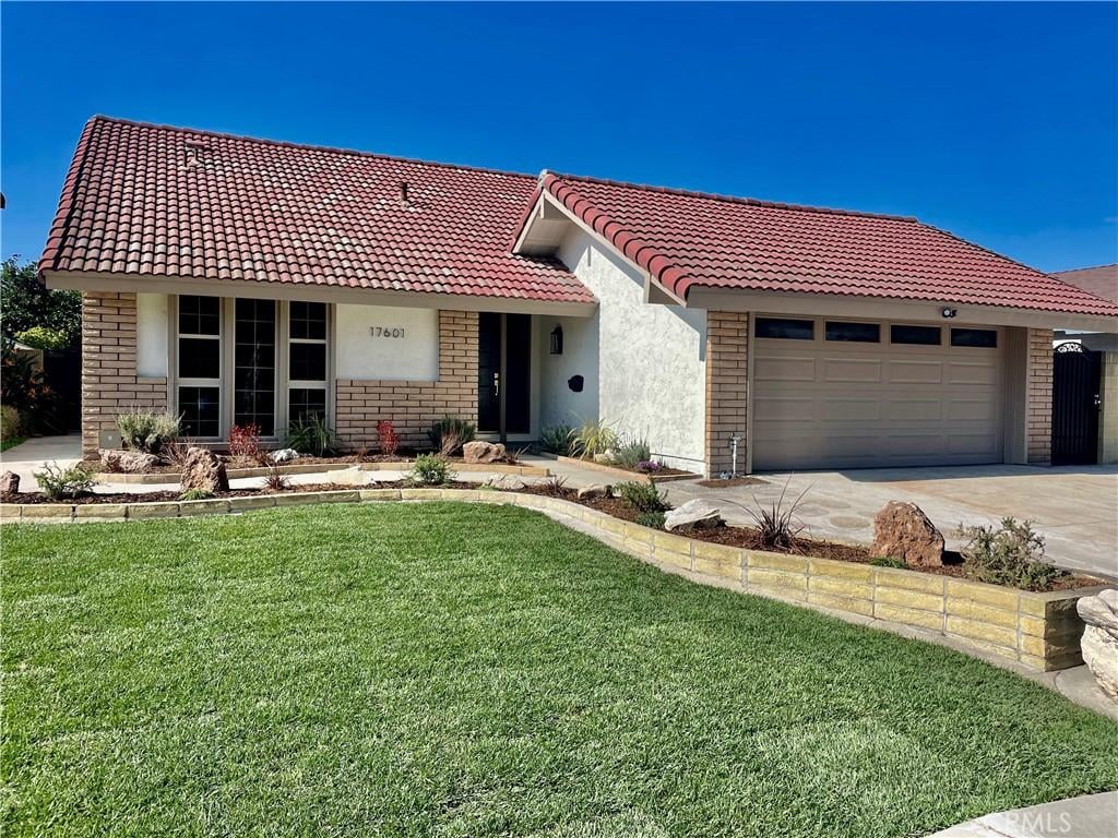 17601 Leal Ave, Cerritos, CA 90703 - view of front facade featuring a garage and a front yard
