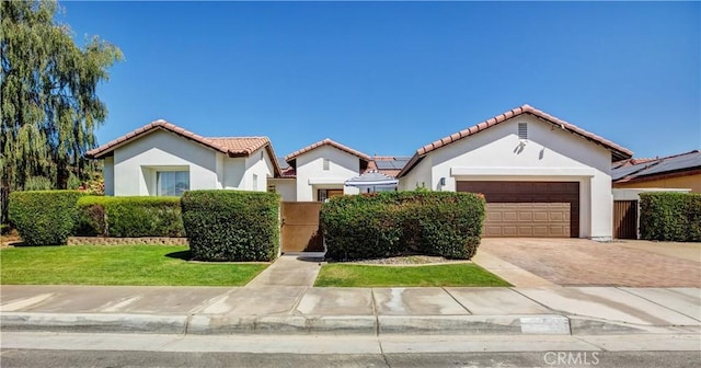 mediterranean / spanish-style house with a front lawn