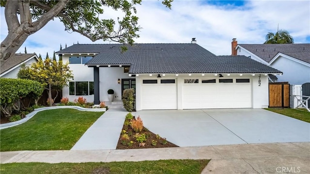 view of front facade with a garage and a front lawn