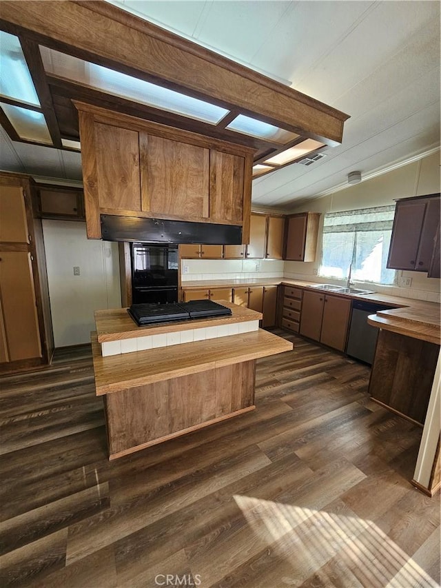 kitchen featuring black gas stovetop, sink, dark hardwood / wood-style floors, lofted ceiling with beams, and tile countertops