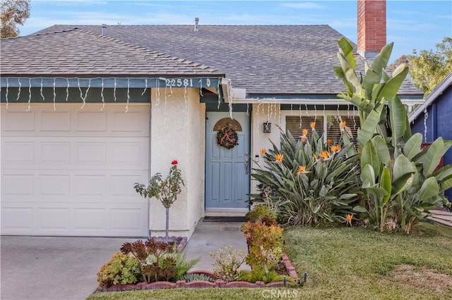 view of front of home with a garage and a front yard