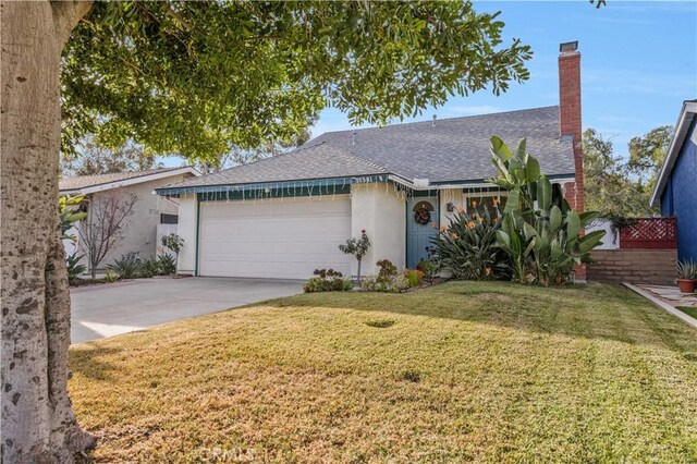 single story home featuring a garage and a front lawn