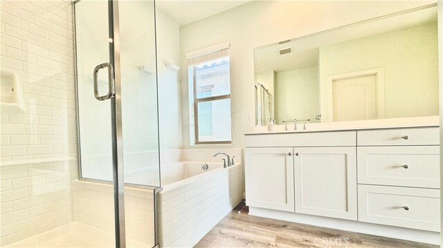 bathroom featuring separate shower and tub, wood-type flooring, and vanity