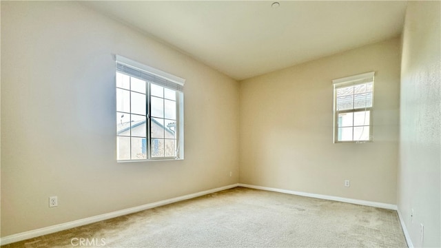 carpeted empty room with a healthy amount of sunlight